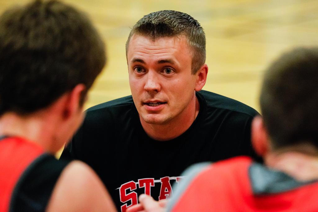 Coach Brant Minor talking with players on the court