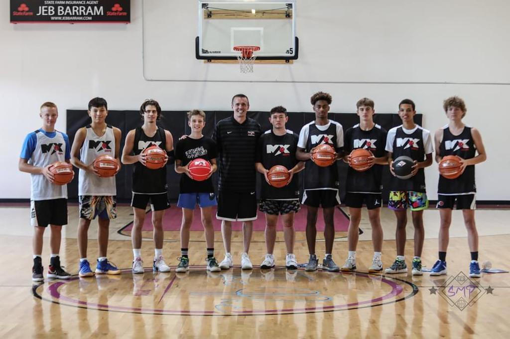 A Max Hoops practice group standing under the basket